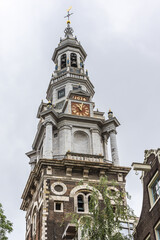 Fototapeta na wymiar Amsterdam Southern church (Zuiderkerk) - Protestant church in Nieuwmarkt area of Amsterdam. Zuiderkerk constructed in 1611. Church tower (1614) dominates surrounding area. Amsterdam. Netherlands.