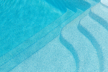 New modern fiberglass plastic swimming pool entrance step with clean fresh refreshing blue water on...