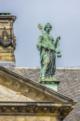 Fototapeta premium Architectural fragments of Amsterdam Royal Palace building (Koninklijk Paleis) at Dam Square. Classicism style Palace built as city hall during Dutch Golden Age (1648 - 1655). Amsterdam, Netherlands.