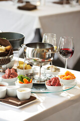 Fondue plate at a restaurant.  Cheese, traditional oil, and chocolate fondue
