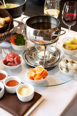 Fondue plate at a restaurant.  Cheese, traditional oil, and chocolate fondue
