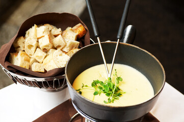 Cheese fondue plate with bread at a restaurant.