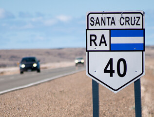 Route 40 sign in Santa Cruz, Argentina, with cars coming from the front.