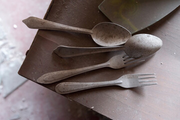 Old dusty cutlery in apartment of ghost town Pripyat