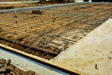 Reinforcement rod and wood forms ready for concrete pour for second half of slab of new commercial building.