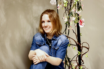 portrait of a young smiling beautiful girl and flowers