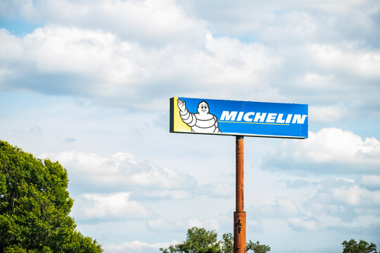 Gainesville, USA - April 26, 2018: Michelin logo sign for tire manufacturer in Florida on highway road with cloudy sky in background