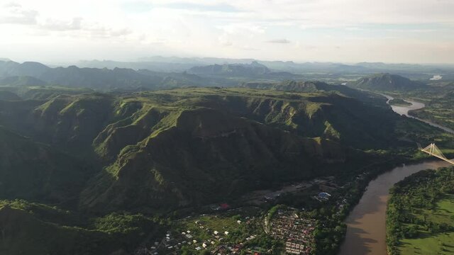 Drone aerial view of colombian highlands in Tolima region and Honda, valley town on Magdalena river riverbanks