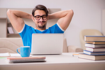 Young male student studying at home