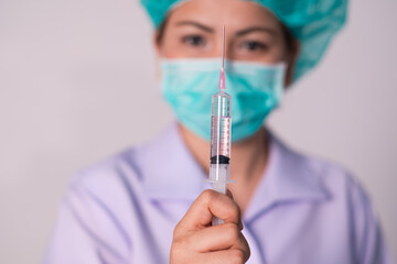 Hand of a nurse with a syringe on white background