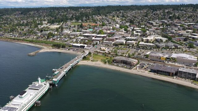 Cinematic 4K drone trucking footage of the downtown Edmonds commercial area, loading ferry at the Kingston terminal near Seattle in Western Washington, Pacific Northwest, in Snohomish County