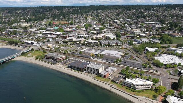 Cinematic 4K drone footage of the downtown Edmonds commercial and residential areas, Kingston ferry terminal looking from the beach and over the terminal