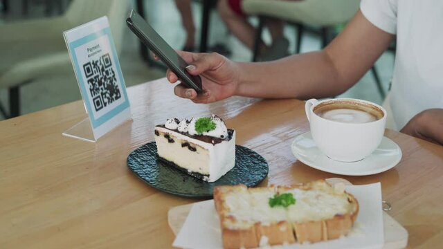 A Woman Scans A Bar Code To Order More Food. A Woman Scans A QR Code To Pay For Cake And Coffee. A Woman Scans The Code To Collect Points For Redemption. Concept Technology Support.