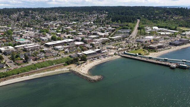 Cinematic 4K drone footage of the downtown Edmonds commercial area, loading at the Kingston ferry terminal, Olympic Beach near Seattle in Western Washington, Pacific Northwest, in Snohomish County
