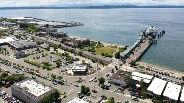 Cinematic 4K drone footage of the downtown Edmonds commercial area, loading ferry at the Kingston terminal, waterfront marina, near Seattle, Pacific Northwest, in Snohomish County