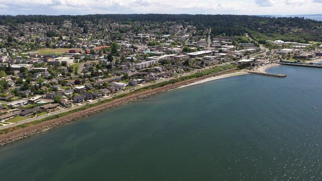 Cinematic 4K drone dolly footage of the downtown Edmonds commercial area, Kingston ferry terminal, shoreline and beach near Seattle in Western Washington, Pacific Northwest, in Snohomish County