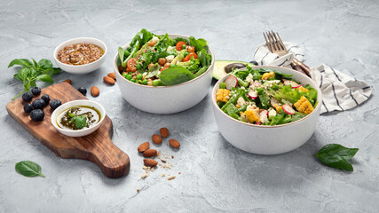 Assorted vegan salads on dark gray background. Seasonal food concept.