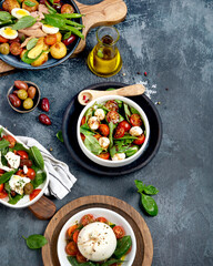 Assorted salads on dark gray background. Seasonal food concept.