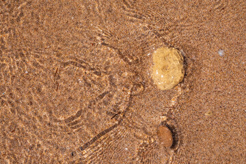 Soft wave of the sea on the sandy beach.