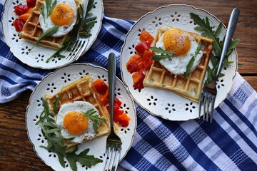 Healthy breakfast . Freshly made, delicious meal of eggs and vegetables. Gluten-free buckwheat waffles with fried eggs Top view