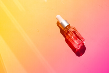 Dropper glass bottles with pipette. Transparent hyaluronic natural beauty mineral product and eco serum skin care concept. Top horizontal view copyspace. Summer juicy colors