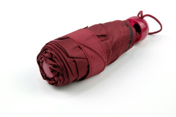 Dark red foldable umbrella on white compact, easy to carry