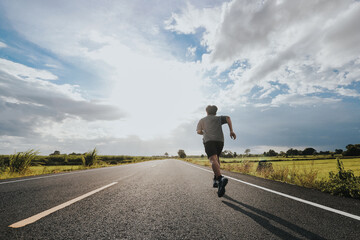 The man with runner on the street be running for exercise.