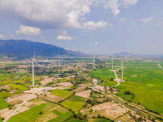 Wind power plant. green meadow with Wind turbines generating electricity