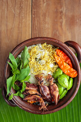 Nasi Liwet Sunda. A traditional Sundanese rice dish of white rice cooked with spices and topped with salted squid, anchovies, chili peppers and broad beans