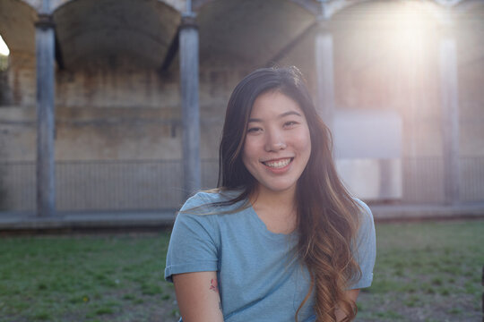 Young Asian woman enjoying time outdoors at enclave