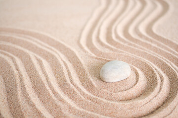 Japanese zen garden stone on wave sand beach. rock or pebbles with copy space. for aroma therapy spa on summer holidays. meditation wellness and tranquility Japanese concept.