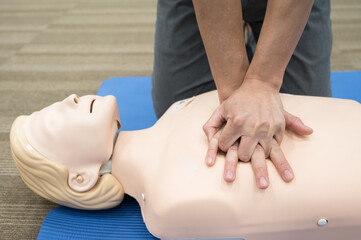 Demonstrating CPR (Cardiopulmonary resuscitation) training medical procedure on CPR doll in the class.Doctor and nurse students are learning how to rescue the patient.First aid for safe life concept.