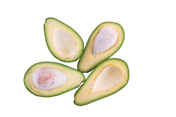 Two ripe sliced avocados on a white background