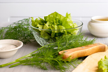 salad dill salt olive oil on a sunny kitchen table concept vegetarianism proper nutrition diet