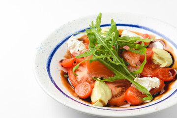 Tomato and salmon salad with cheese and spices. Traditional Italian cuisine, Italian concept.