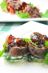 Meat and vegetable salad with cucumbers, tomatoes, red onion and fresh rosemary. Concept for a tasty and healthy meal.