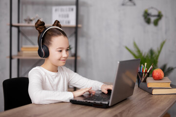 technology, internet, school, homework and distance education concept - school girl using laptop,...