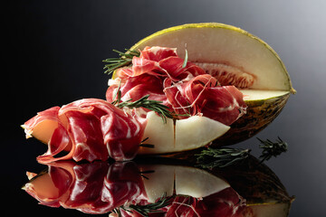 Prosciutto with melon and rosemary.