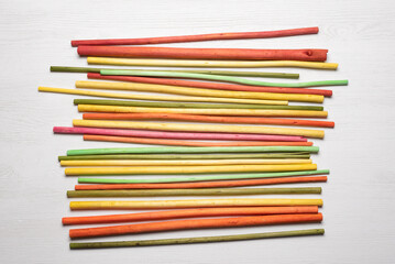Colorful aroma sticks on the white flat lay background.