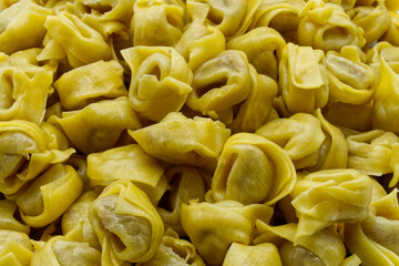 Traditional Italian Raw Tortellini Background. Italian Fresh Pasta.