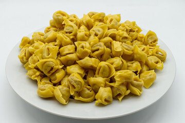Traditional Italian Raw Tortellini in a dish, isolated on White Background