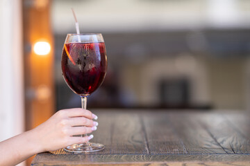 Female ready to drink negroni in restaurant