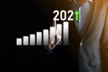 Business development to success and growing growth year 2021 concept.Plan business growth graph in year 2021 concept.Businessman plan and increase of positive indicators in his business