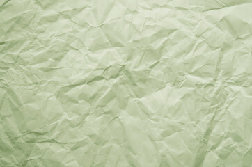Texture of crumpled imitation craft paper. Recycle old pistachio green paper background