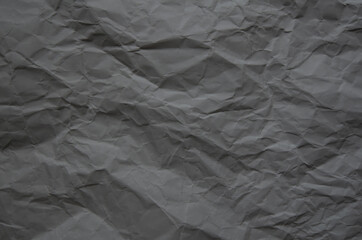 Texture of crumpled imitation craft paper. Recycle old dark gray paper background