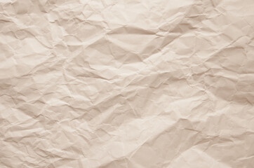 Texture of crumpled imitation craft paper. Recycle old champagne beige paper background