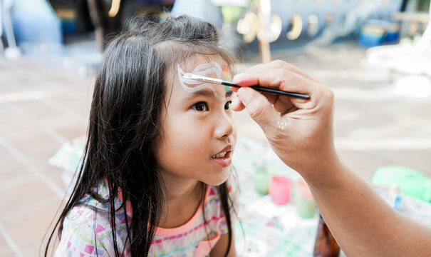 happy asian Child preschooler with face painting. Make up.
