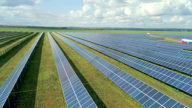 The process of converting the energy of the sun into a permanent electric current using the principle of photo effect. View of a solar farm located in the valley. High quality. 4k footage.
