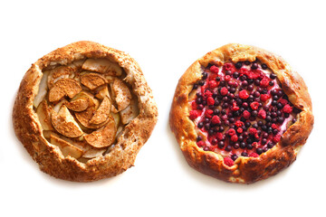 Two homemade open cakes with different fillings. Pie with pear and pie with berries, top view, isolated on white background.