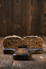 Artisan rye bread with dried apricots, prunes and seeds cut on half